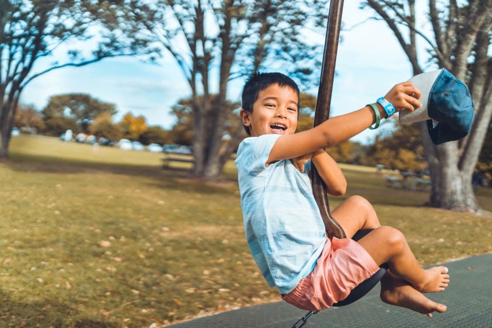 Young child paying on a swing