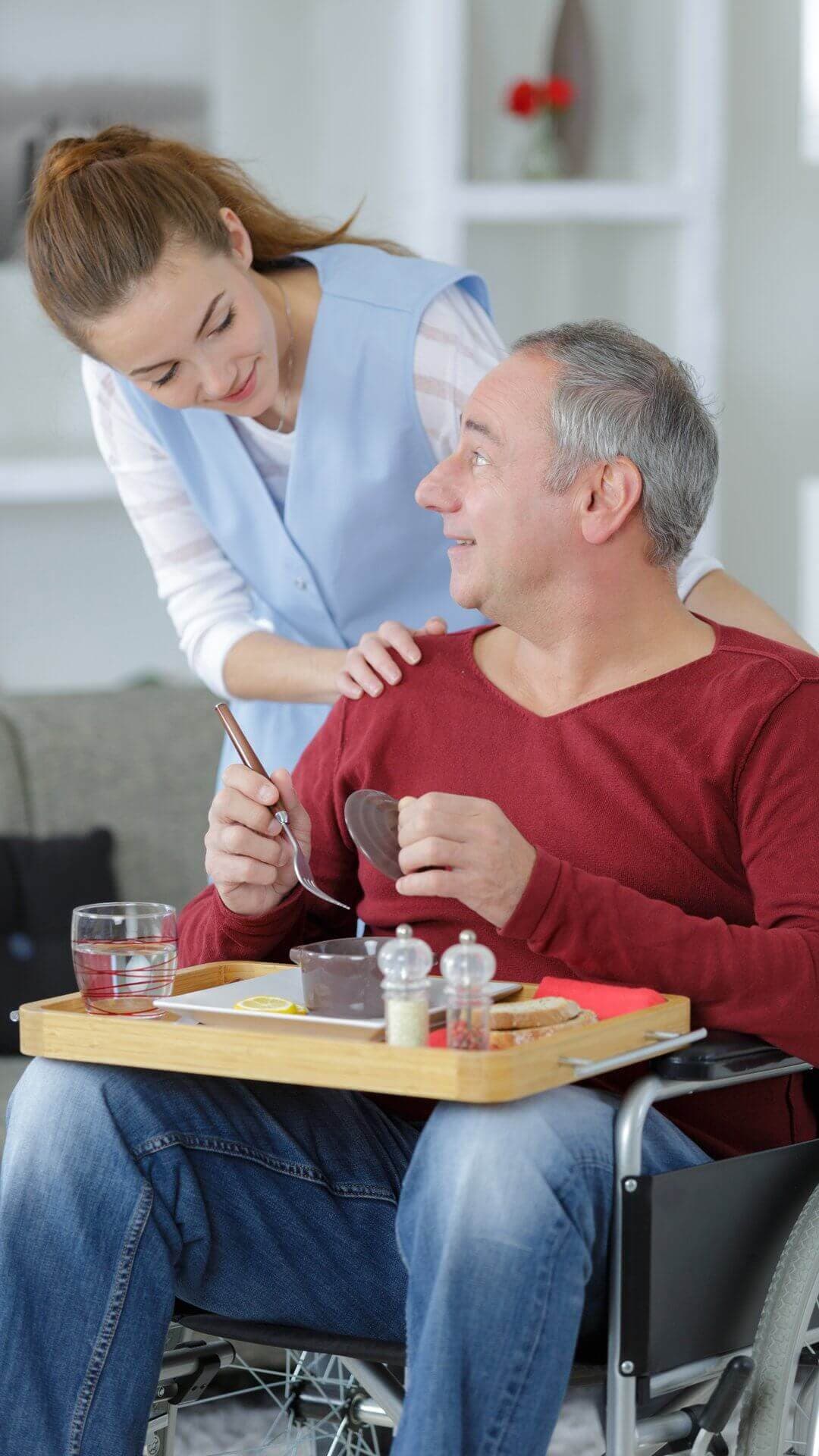 A female nurse helping a man with disability
