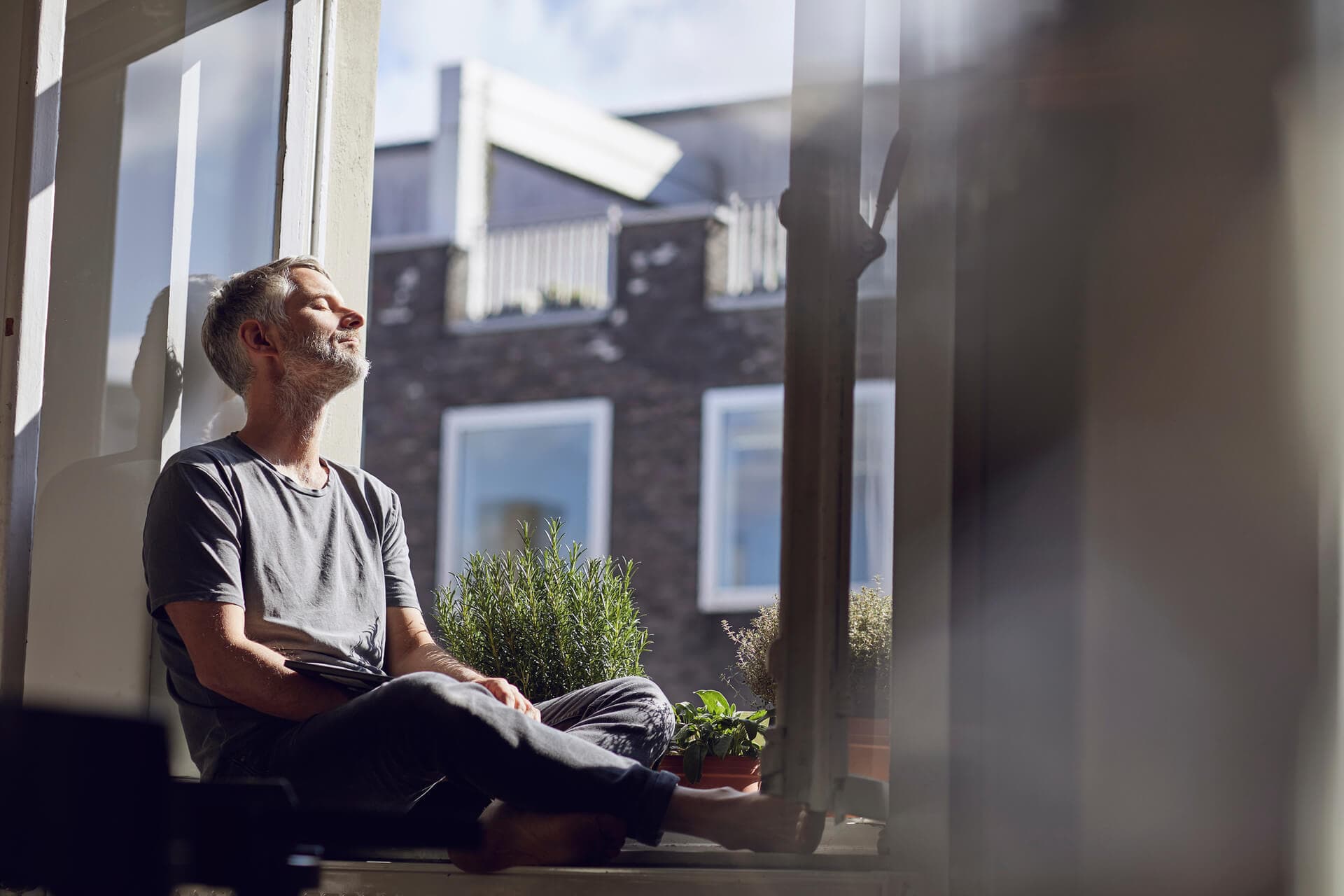 man relaxing staring out the window