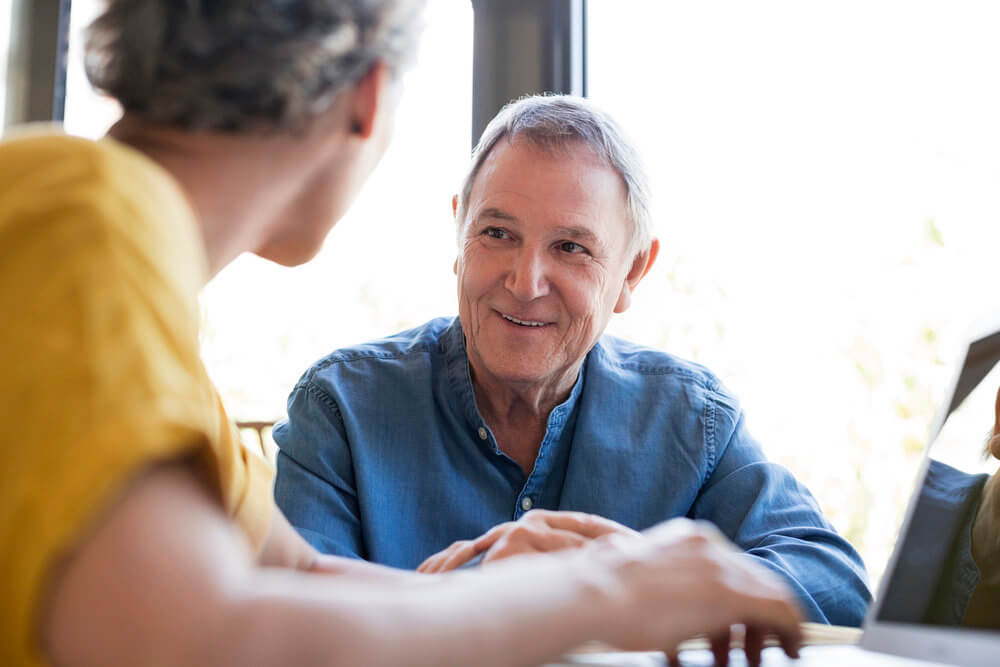 Older man having a conversation, engaged and smiling