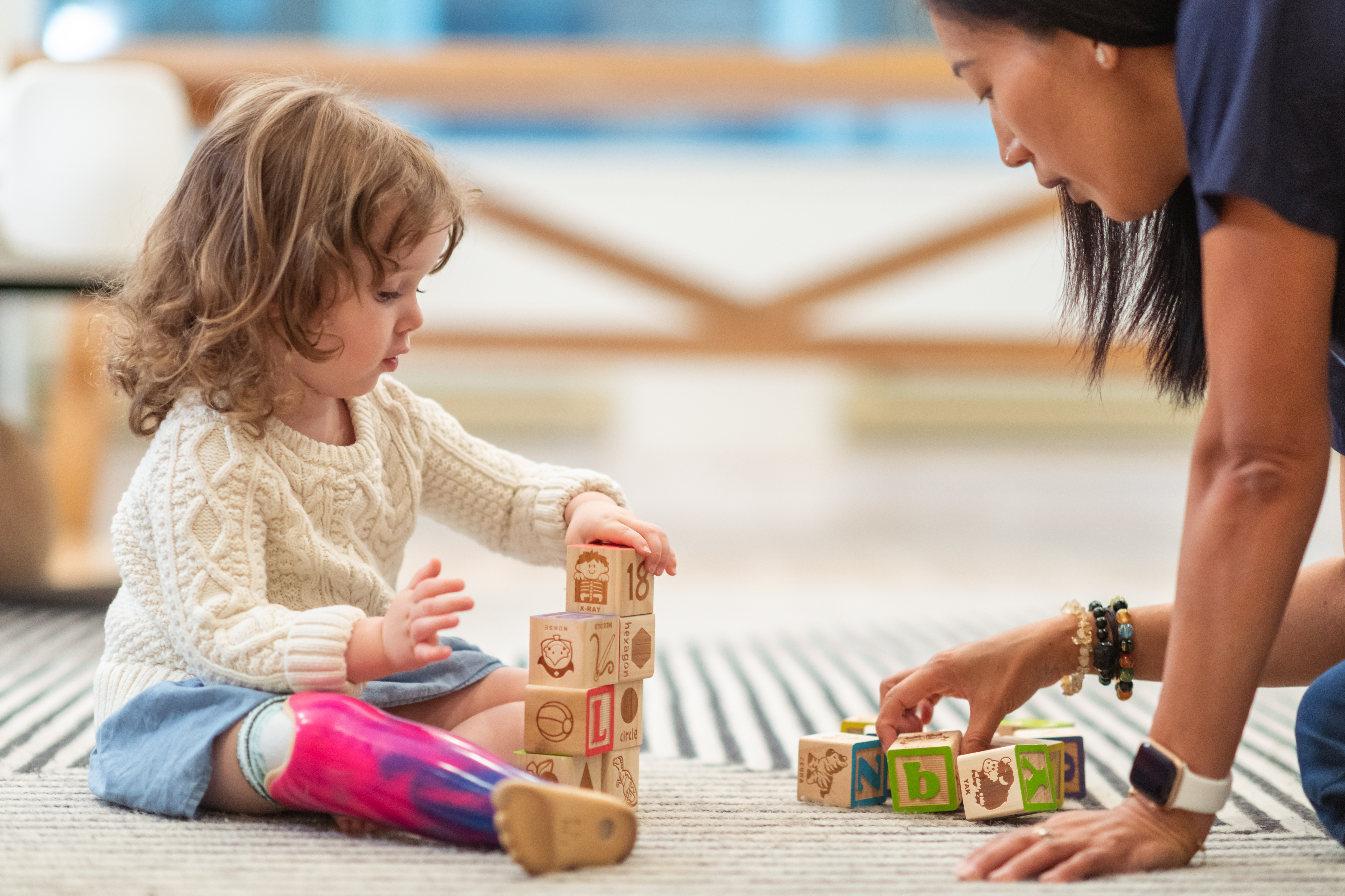 Child and therapist with toy blocks