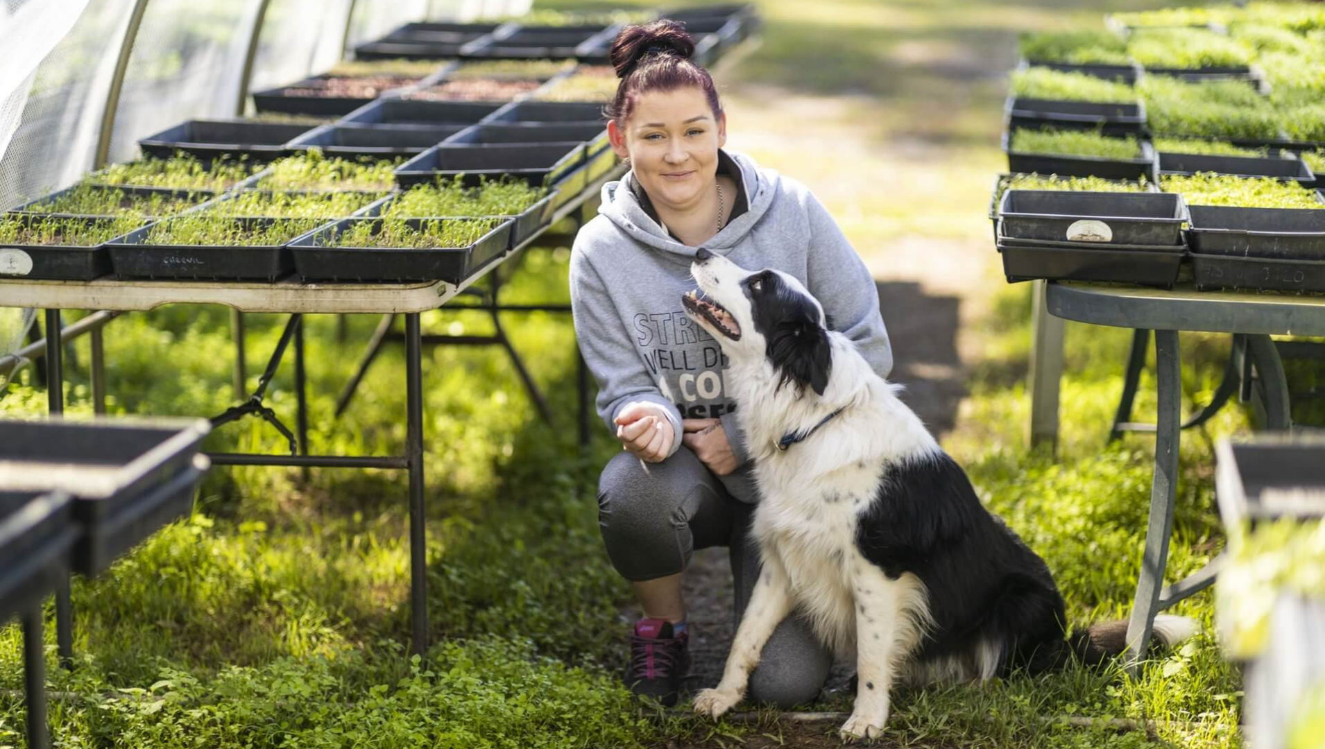 lady with a dog in a growing facility
