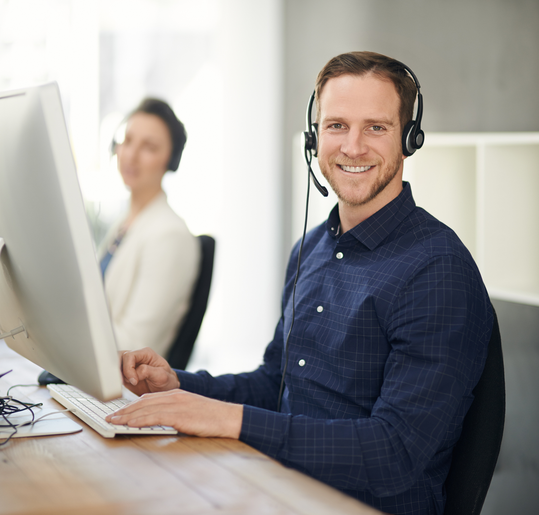 Man with headset working in a caller help desk